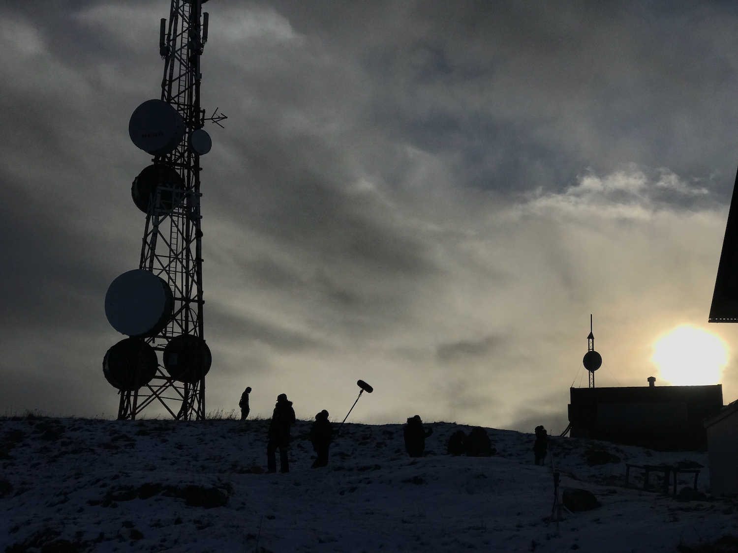 Film crew silhouetted against Icelandic sky
